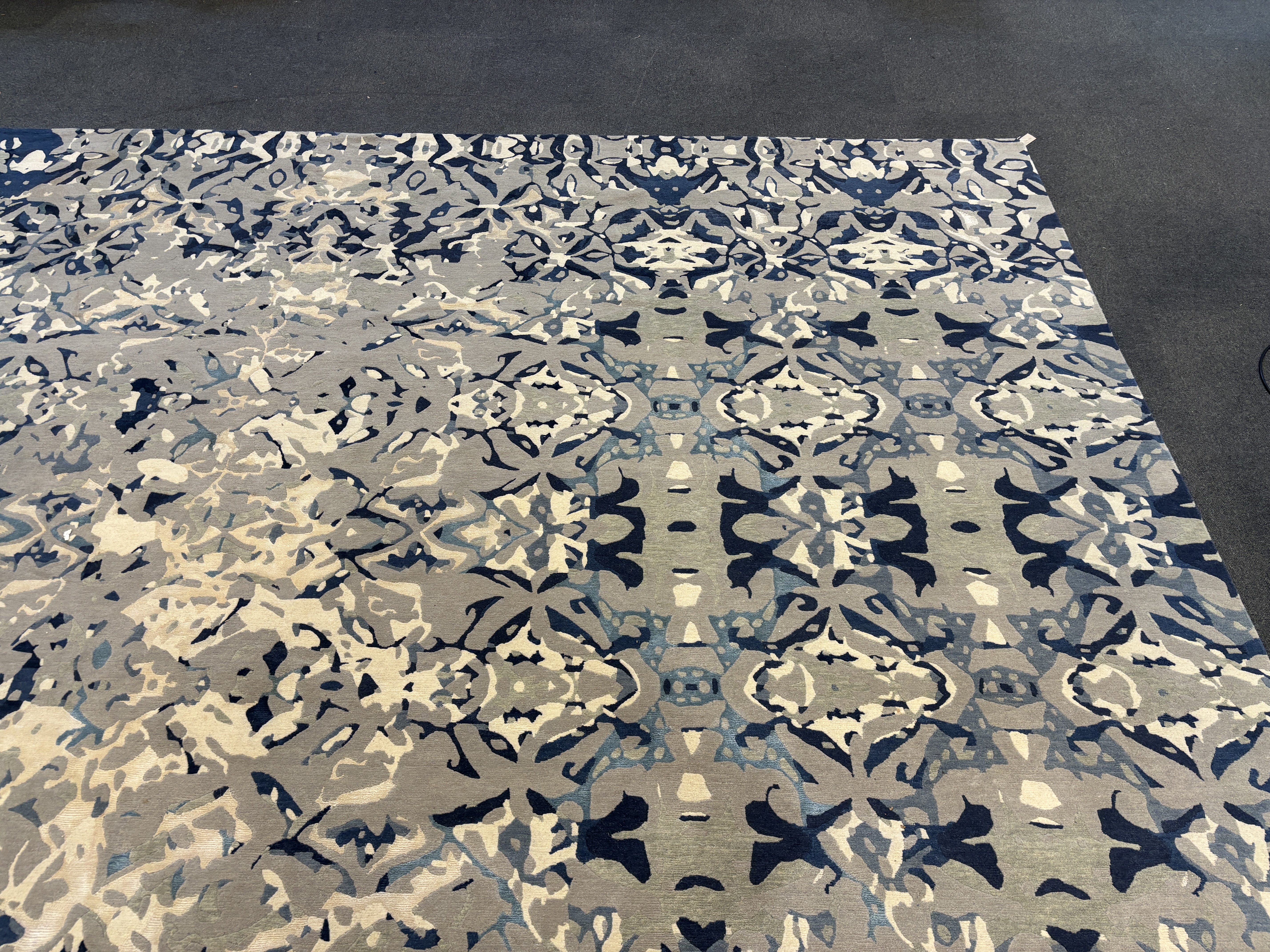 An Elizabeth Ashard 'Moghul', a silk and wool blue tones pattern carpet, 665 x 440cm